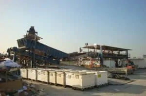 Interior Removal Specialist, Incorporated’s Construction and Demolition Debris Processing Facility. The processing line is in the background, with debris boxes in the front.